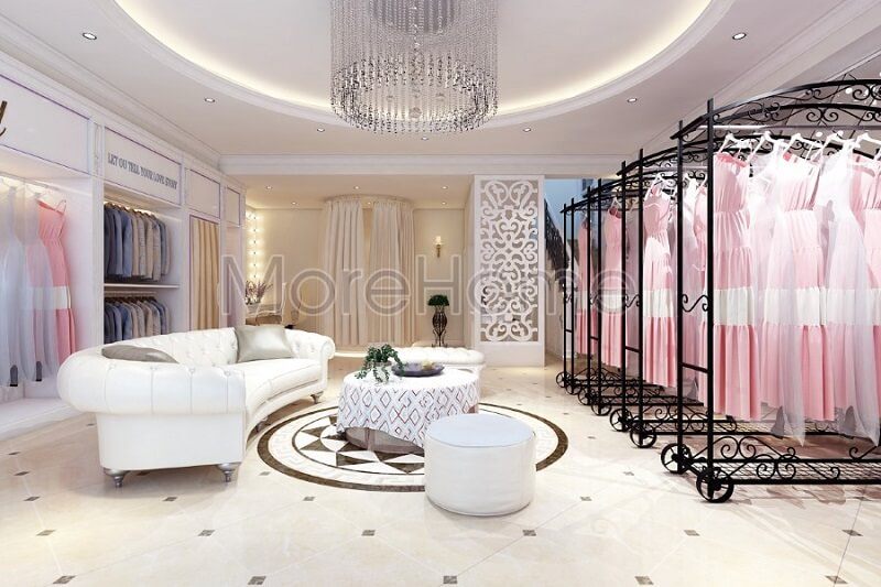 Thiết kế nội thất showroom áo cưới Calla Lily đẹp với sự có mặt của bộ sofa da màu trắng cùng với thanh treo quần áo màu đen tạo điểm nhấn nổi bật cho không gian căn phòng